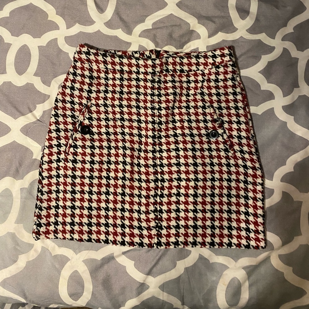 Cute plaid mini skirt with button embellishments and a zipper in the back. Small
